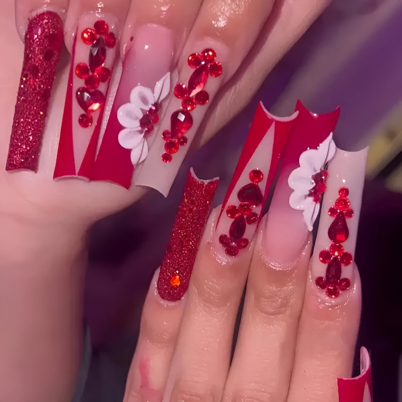 Set of sweet flower pattern press-on artificial nails with prismatic red diamonds in a long European square style.