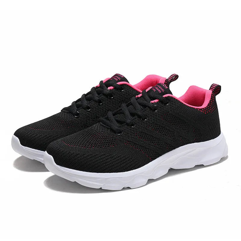 Women's sports running shoes in white with mesh and Flyknit upper, flat heel, and lace-up front