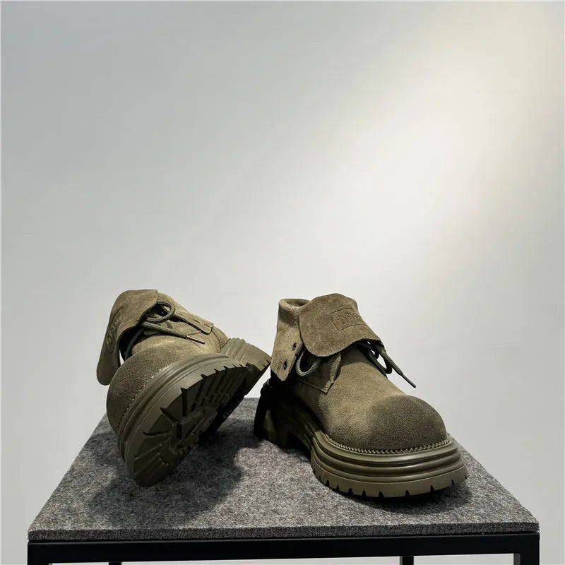 Distressed brown cow suede retro worker boots with thick soles and lace-up design.
