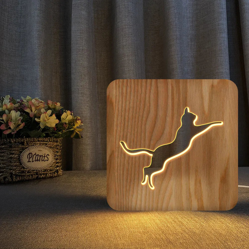 Solid wood 3D cat silhouette night light with hollow design and USB power cord.
