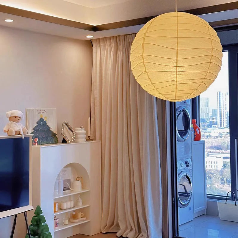 Japanese style rice paper ceiling chandelier light fixture in a living room setting.