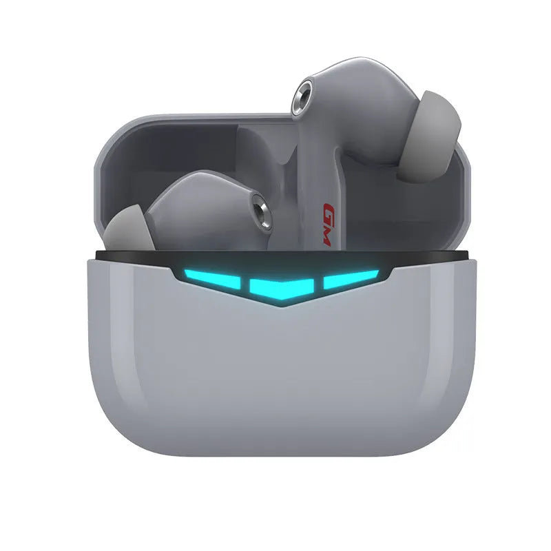 Black true wireless gaming earbuds with charging case and three pairs of silicone ear tips on a grey background.