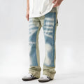 Yellow and blue retro patchwork jeans with splash-ink and distressed detailing on a mid-rise denim fit