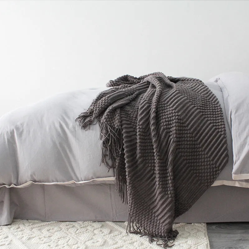 Small grey polyester nap blanket folded, showing its 127cm by 170cm size.