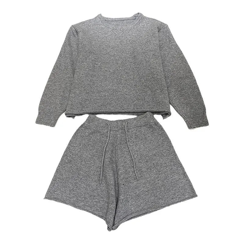 Woman wearing a loose grey knitted long sleeve sweater and matching wide-leg shorts set, front and back view.