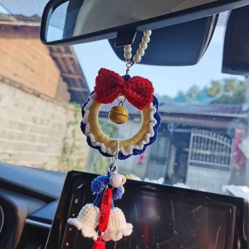 Handmade plush yarn Snow White character car hanging ornament on a clear background.