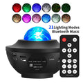 Black parallel style Bluetooth starry sky projection lamp with remote control on a desktop.
