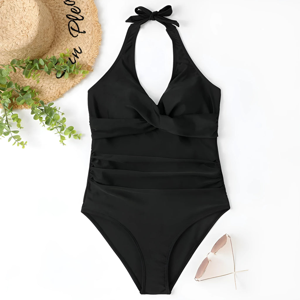 Women's solid colour one-piece swimsuit with cross-back straps on a mannequin.