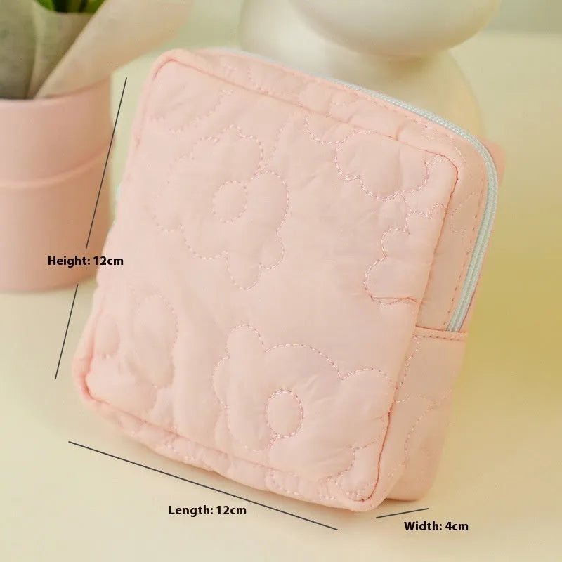 Quilted silk cosmetic storage bag for women in pink, blue, yellow, green, or white.