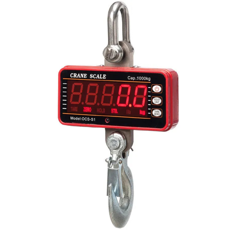 Orange electronic crane scale with digital display for 500 kg loads in warehouse.