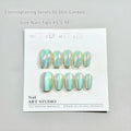 Set of electroplated Cat's Eye and aurora press-on nails in short ladder sizes on a white background.