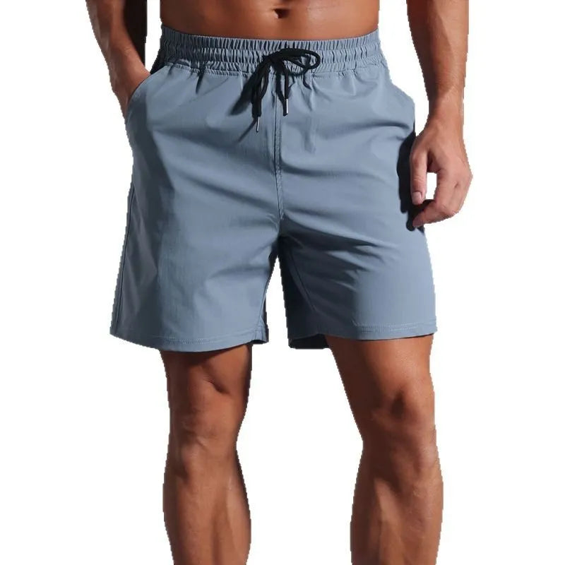 Men's loose straight-leg shorts in quick-drying polyester fabric available in four colours