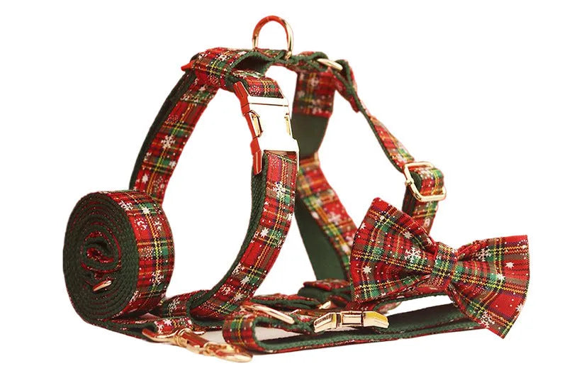 Christmas pet collar four-piece set with green background snowflake design showing dog collar, leash, vest and matching bow