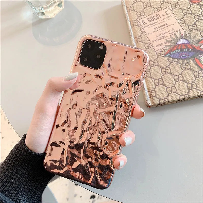 Rose gold folded TPU back cover case for iPhone on a plain background.