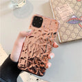 Rose gold folded TPU back cover case for iPhone on a plain background.