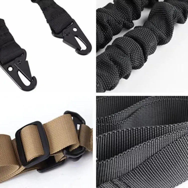 Black crossbody nylon survival tool placement rope with metal buckle and elastic tension adjustment on plain background