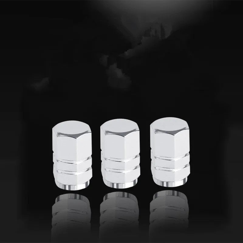 Set of five aluminium alloy car valve caps in black, blue, gold, red, and silver, designed for tyre valve stems with screw-on threading.