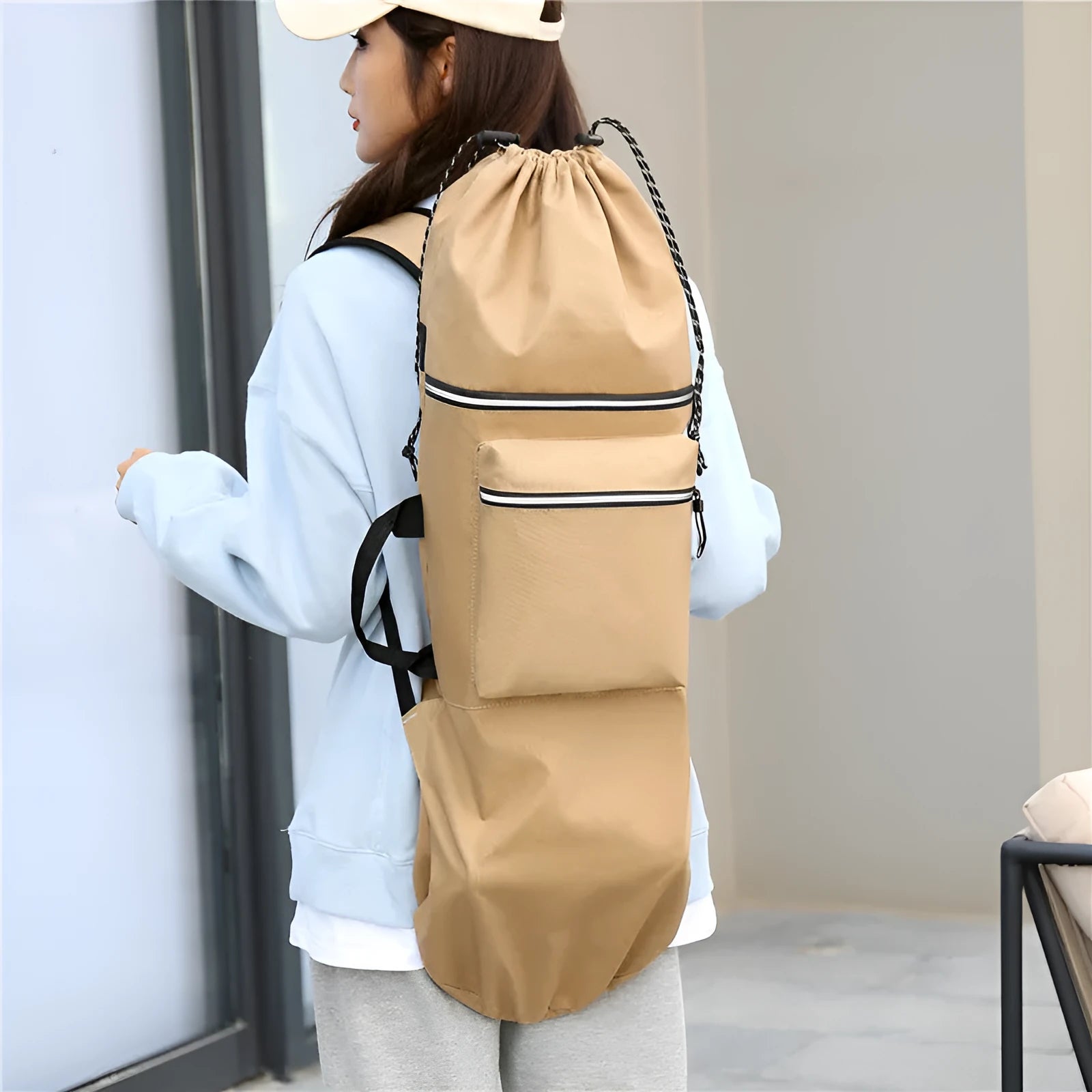 Black waterproof nylon skateboard backpack on a bench, showing its size and straps for carrying long equipment.