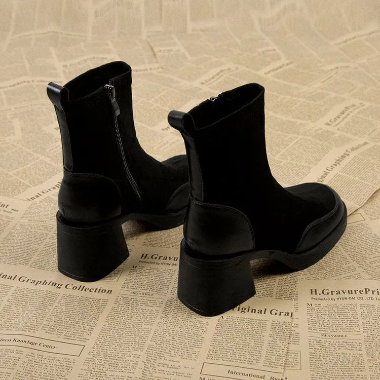Women's black Martin boots with chunky heel and thick rubber sole, side view