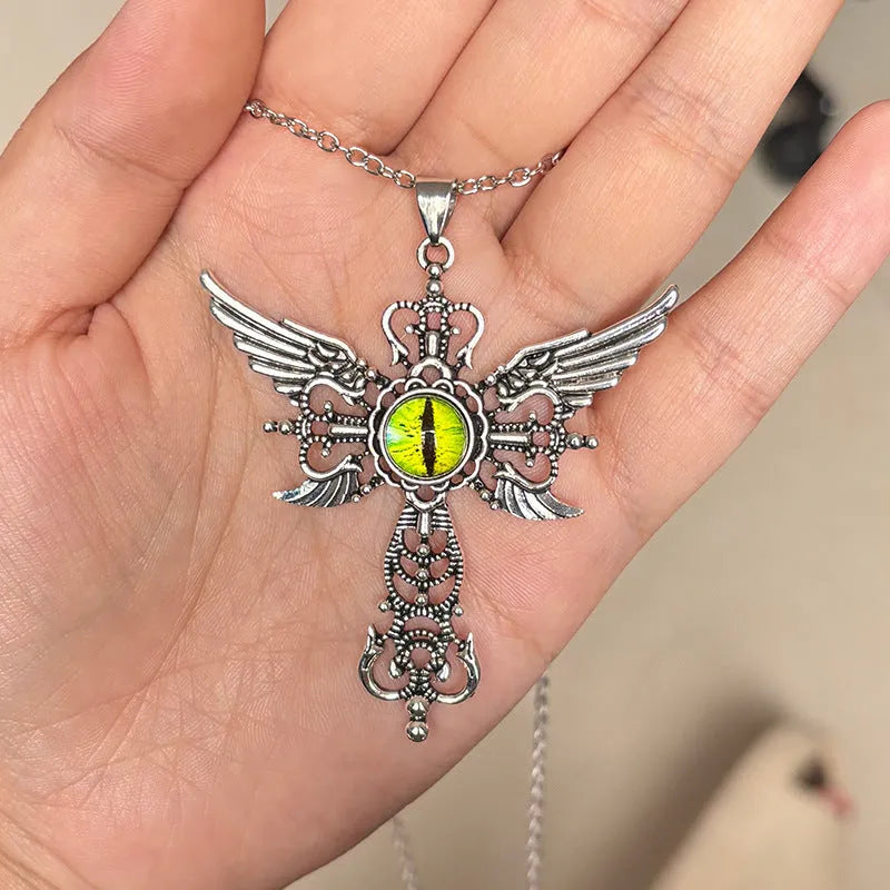 Geometric alloy pendant necklace featuring detailed devil wings and a cross, shown in multiple colour options.