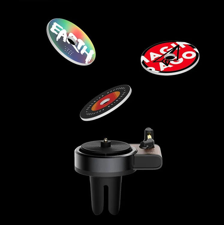 Black turntable car aroma diffuser with ocean scent fragrance tablet on car dashboard