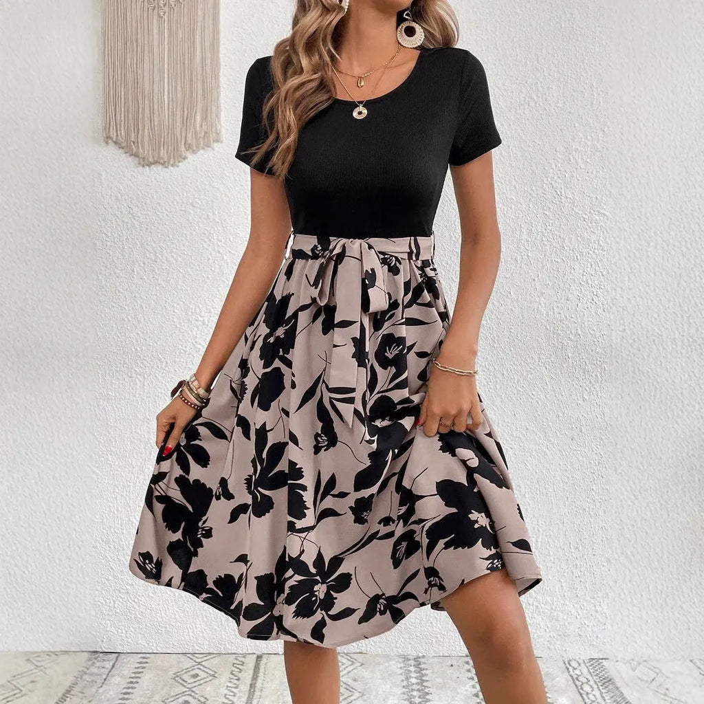 Khaki A-line women's dress with lace-up detail and shoulder straps on a plant print background