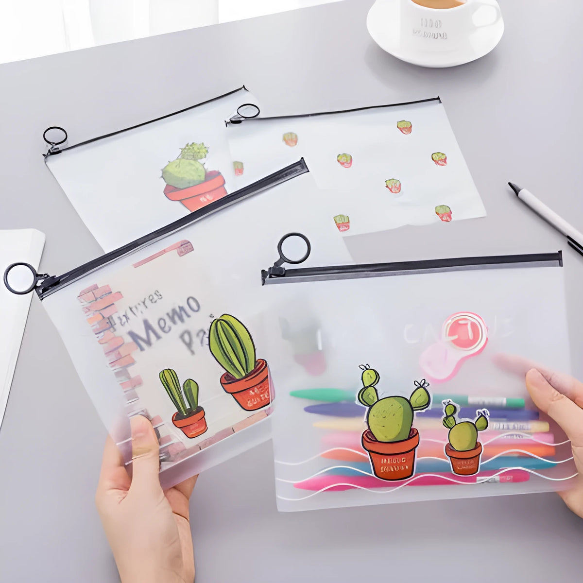 Clear PVC pencil case with cactus print, sealed closure, 17.1 x 21.2 cm, containing pens and pencils
