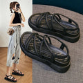 Women's black Roman-style platform sandals with a round toe and slip-on sleeve design.