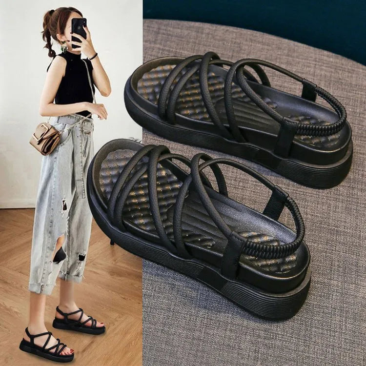 Women's black Roman-style platform sandals with a round toe and slip-on sleeve design.