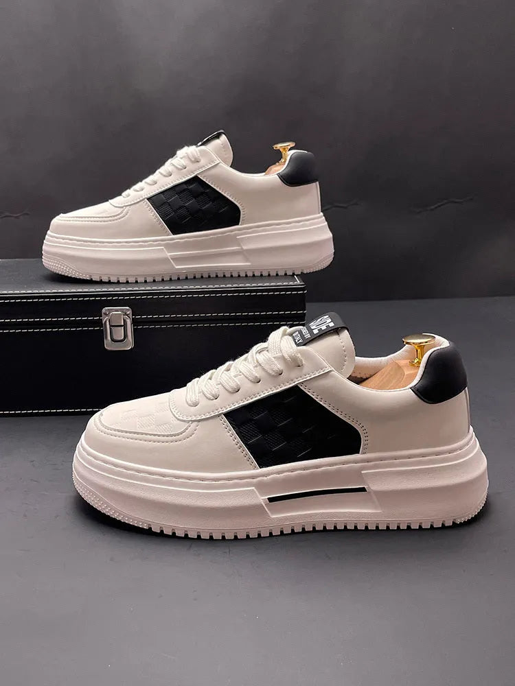 A pair of white and green sports-style casual shoes with a cloth upper on a plain background.