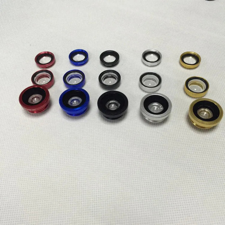 Three smartphone clip-on lenses: fisheye, wide-angle, and macro, in assorted colours on a table