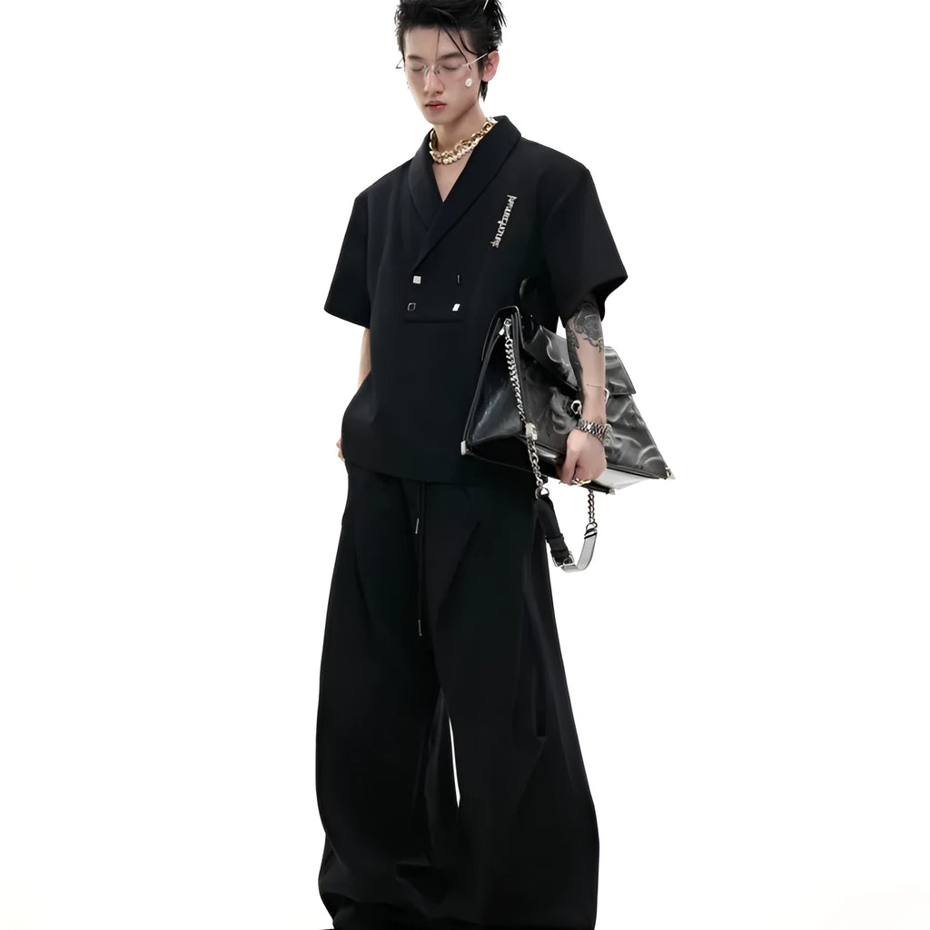 Men's dark grey V-neck cotton sports jacket with padded shoulders and metal trim, paired with matching shorts.