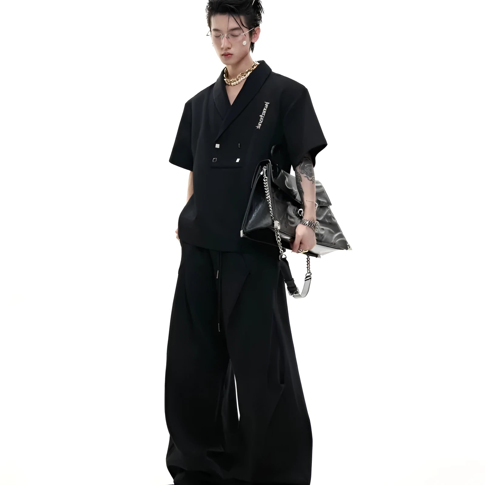 Men's dark grey V-neck cotton sports jacket with padded shoulders and metal trim, paired with matching shorts.