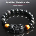Black Mexico Gold Sheen Obsidian crystal bracelet with Pi Xiu charm, showing different bead size options.