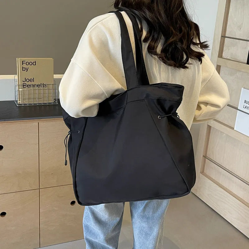 Soft Oxford cloth folding tote bag in five colour options showing shoulder carry design