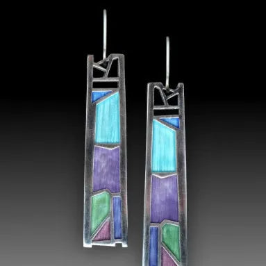 Silver-coloured women's earrings in a water drop shape with an irregular, textured edge design.