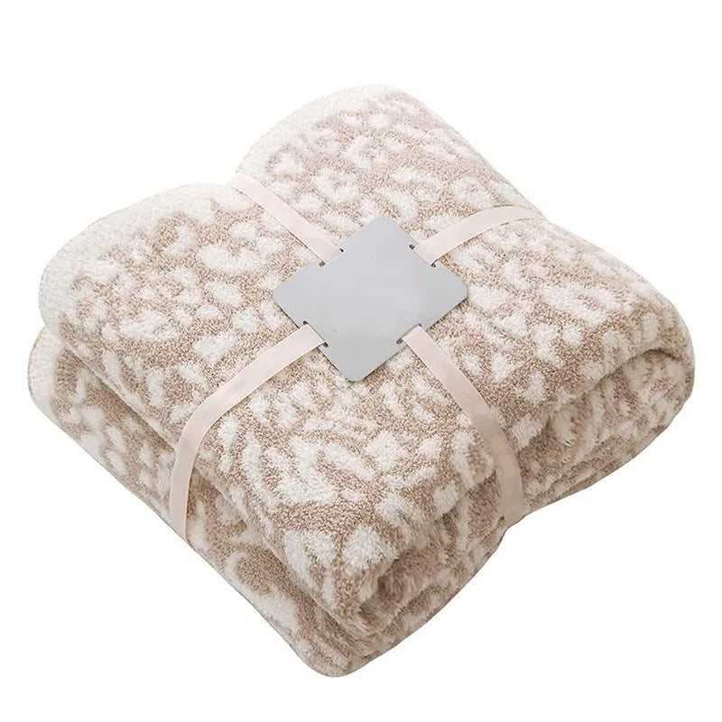 Half velvet leopard print knitted blanket in gray on a sofa, size 130x150cm