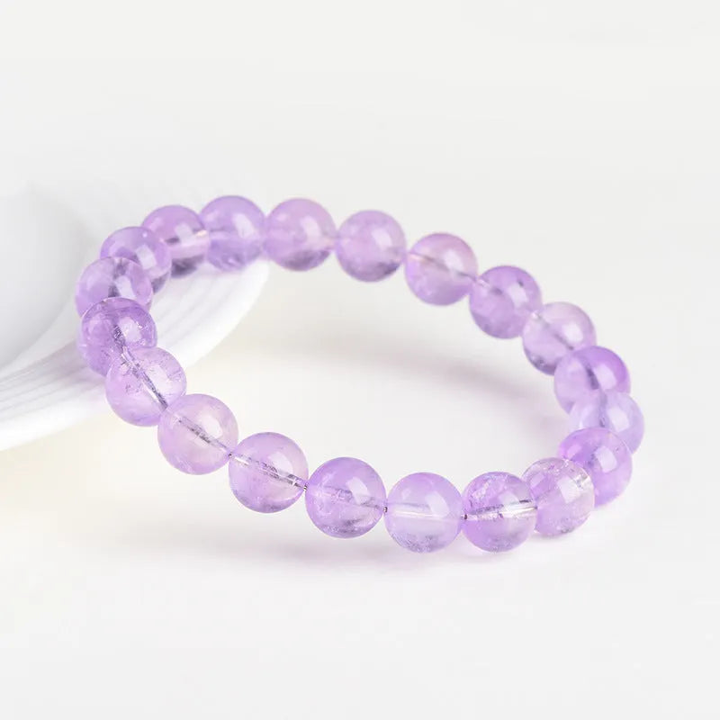 Lavender amethyst crystal bracelet with round beads showing light purple colour and water ripple design.