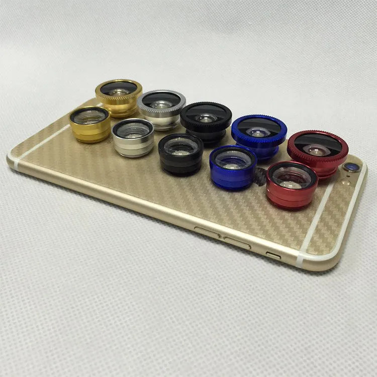 Three smartphone clip-on lenses: fisheye, wide-angle, and macro, in assorted colours on a table