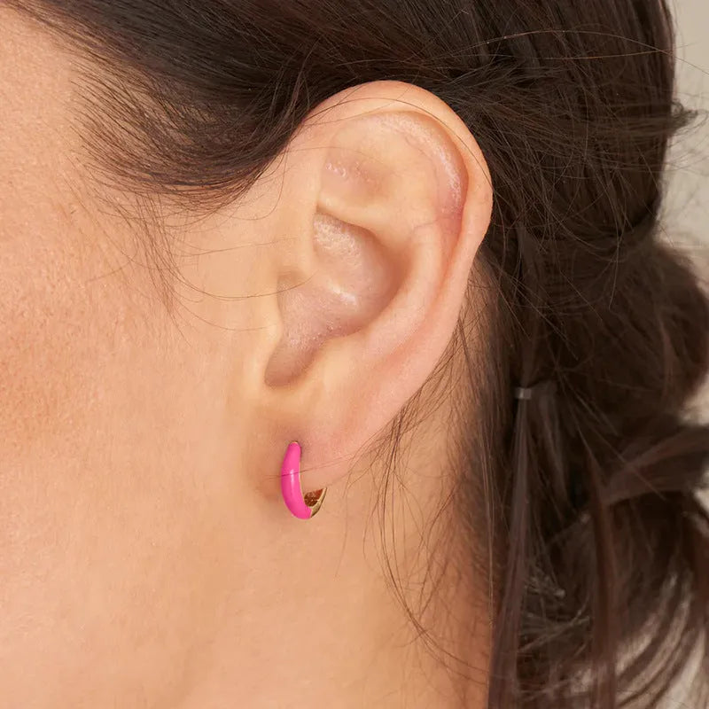 A pair of glossy, U-shaped epoxy oval earrings with a round ring detail on silver copper posts.