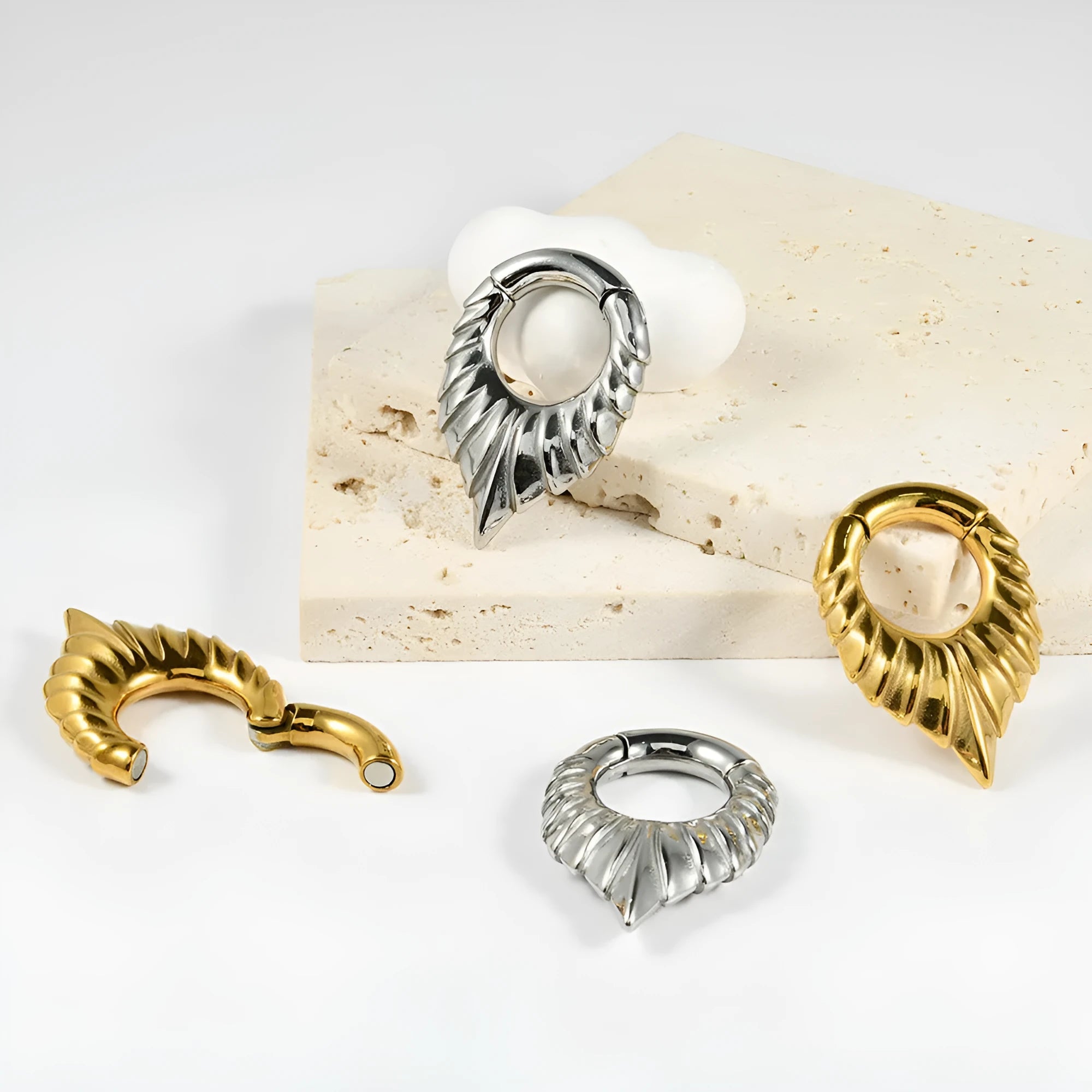 Silver stainless steel drop-shaped egg ear extender with totem engraving for cartilage piercing.