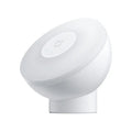 White Mijia Bluetooth bedside table lamp with human body induction on a wooden surface