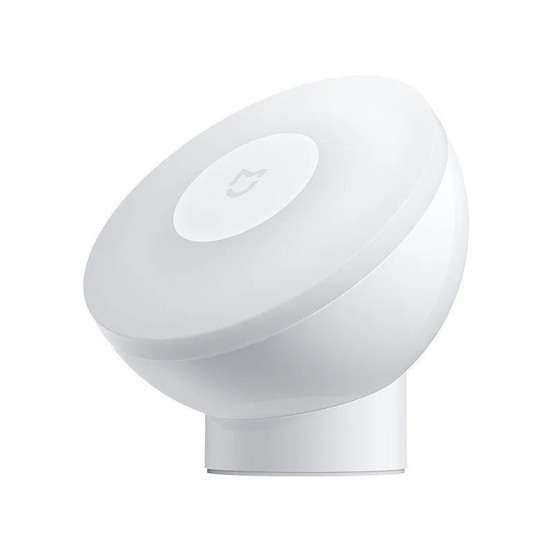 White Mijia Bluetooth bedside table lamp with human body induction on a wooden surface