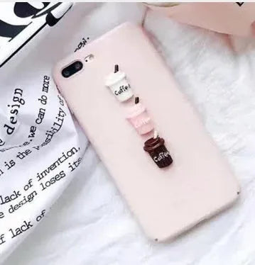 Soft silicone iPhone case with a raised 3D cartoon cat design on the back, shown in pink.