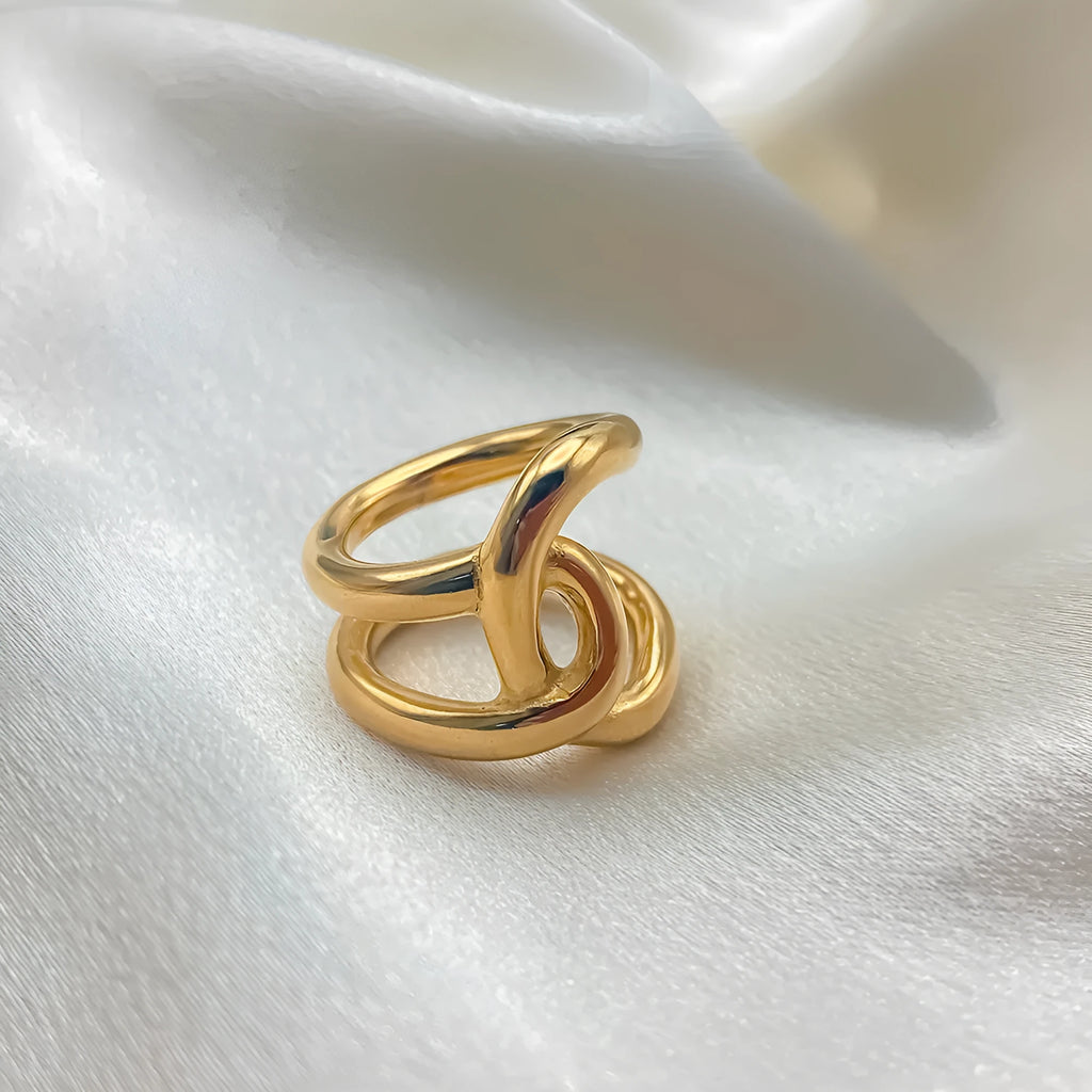 Geometric U-shaped adjustable ring for women with a knotted detail, shown in stainless steel gold tone finish.
