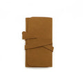 Brown PU leather jewellery storage pouch open to show microfiber lining, with earrings and a ring inside.