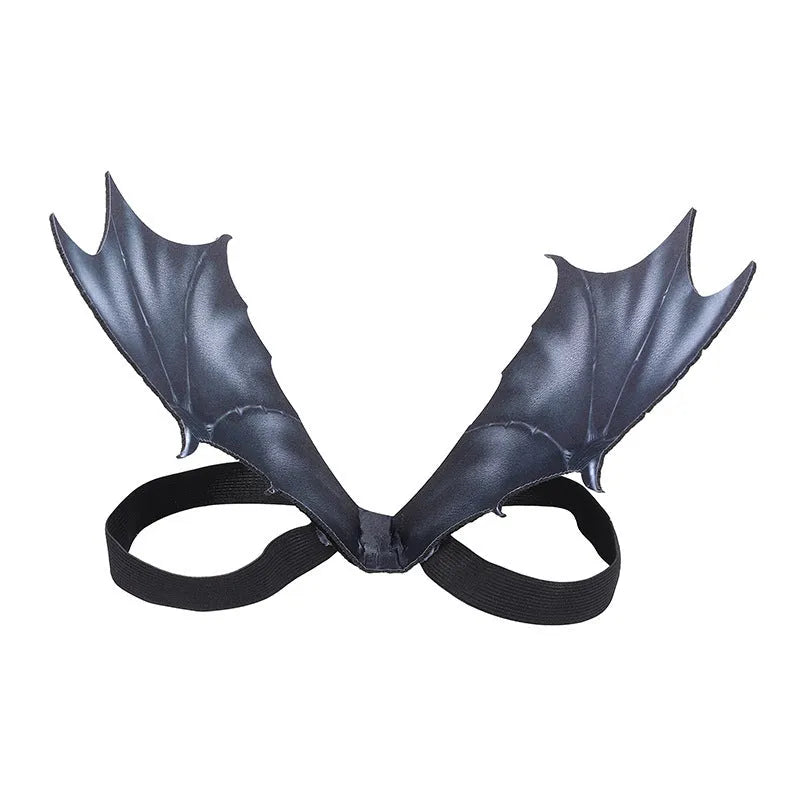 Black cloth bat wings costume accessory for a dog or cat on a Halloween background.