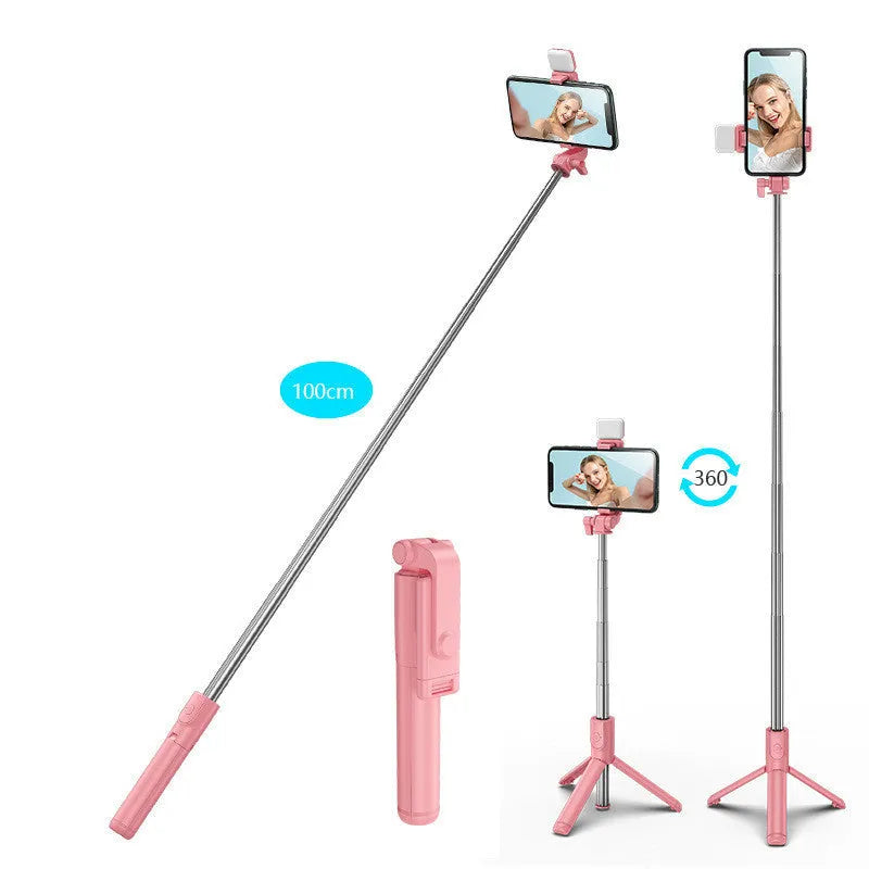 Black aluminium Bluetooth selfie stick with extended tripod legs and a phone mounted in the 360-degree rotating holder.