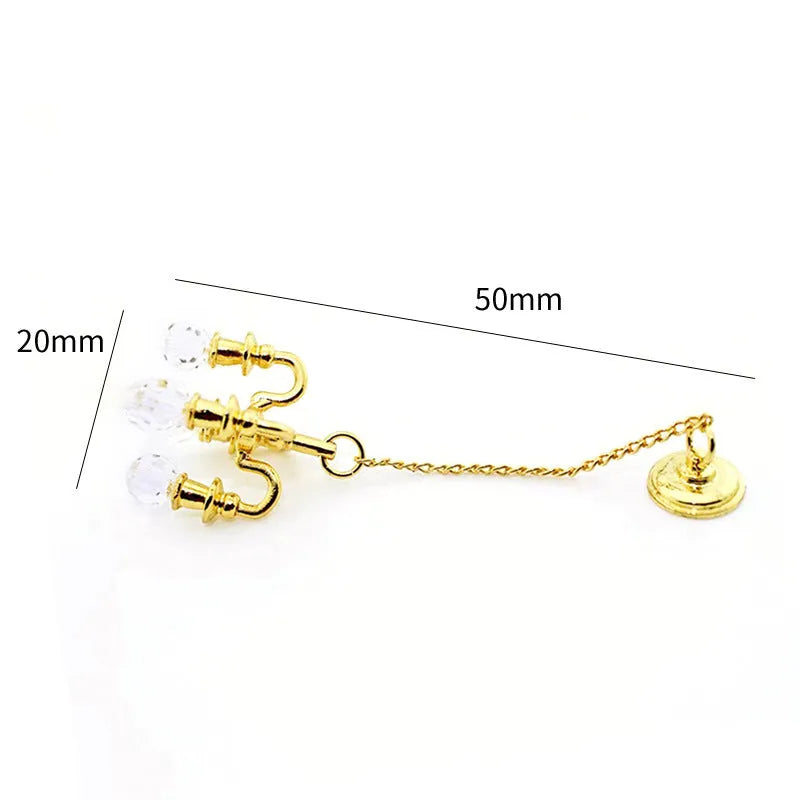 A small gold or silver metal photo prop decoration measuring 5 by 2 centimetres.