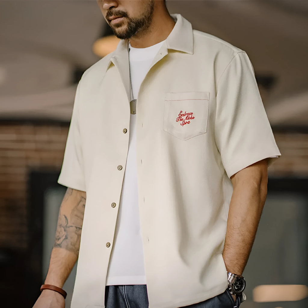 Light apricot men's shirt with bamboo floral pattern and Cuban collar.